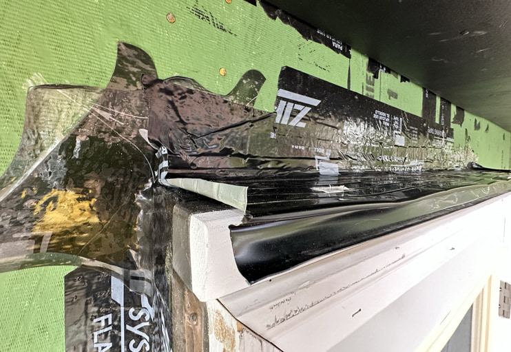 Door drip cap installed and flashed.