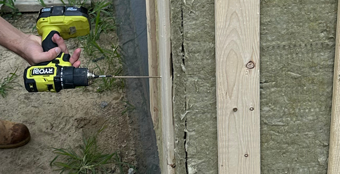 Screwing 5 inch screws into furring strips.