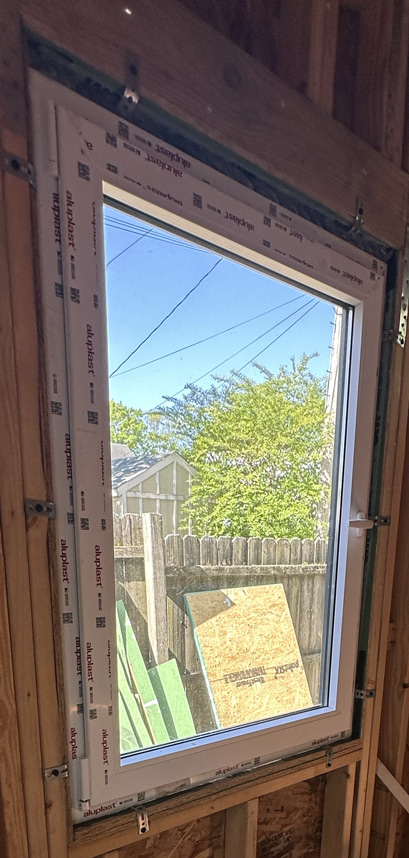 Screwing the window clips into the studs